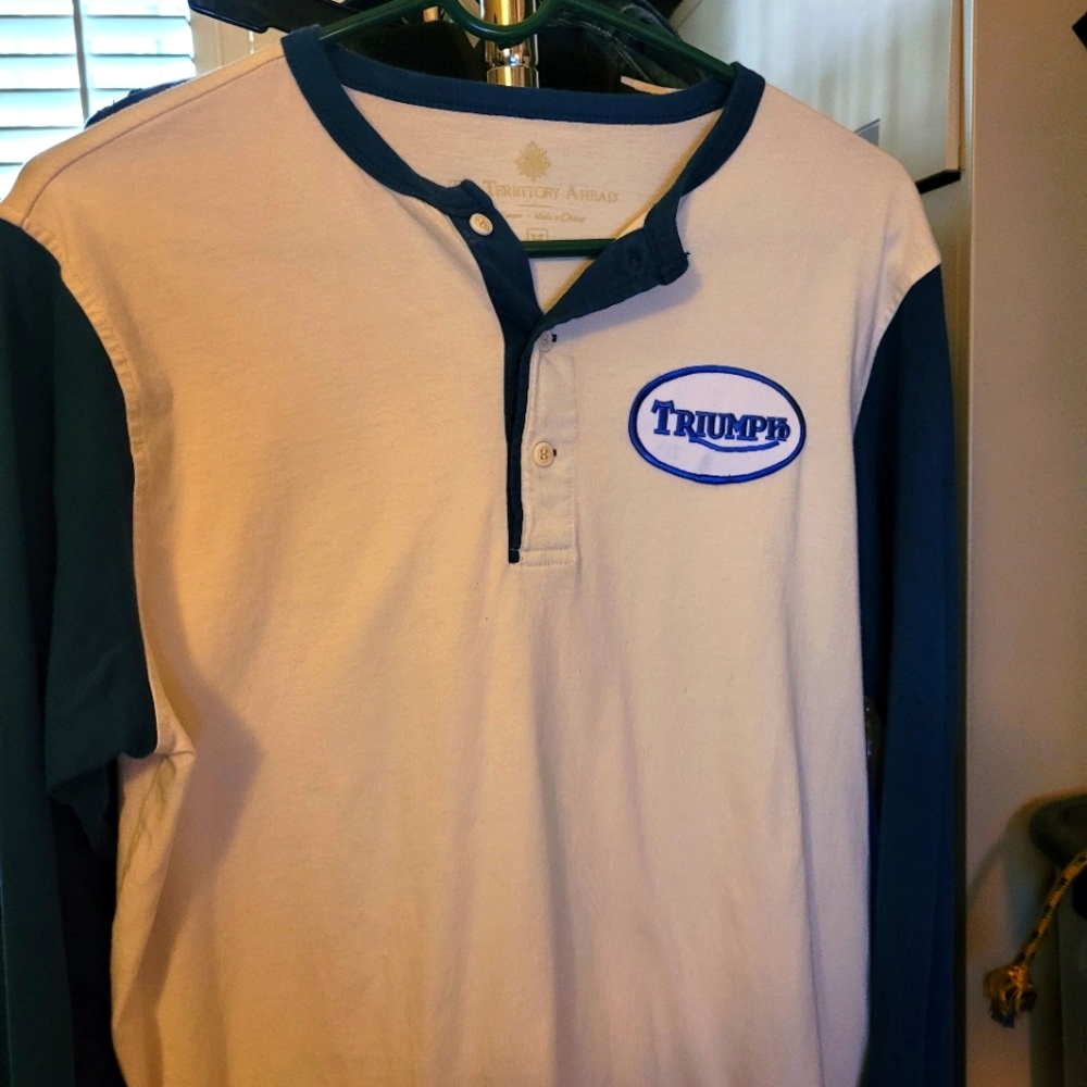 Triumph white and blue baseball jersey.